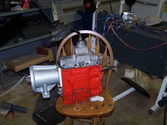 NP435 transmission with red painted casing and silver front housing, sitting on a wooden chair