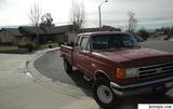 Red 1989 Ford F-250 pickup truck parked in a driveway