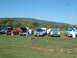 1978 Ford Mustang II - A light blue coupe is displayed with its hood open at an outdoor car show, alongside other vehicles.