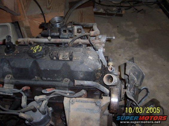 Engine block with oil cap and distributor cap visible