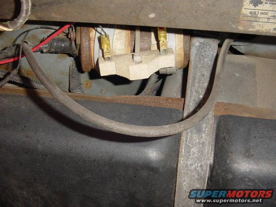 Close-up of a fuel pump's electrical connector with wires attached