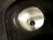 1967 Ford Mustang - Interior view of an engine cylinder head port with a small central hole visible.