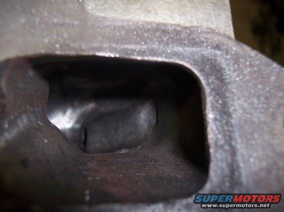 Engine cylinder head port interior. Supermotors.net logo visible