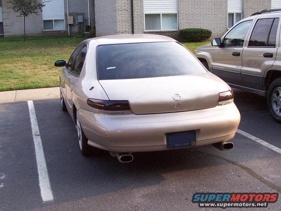 Tan 1998 Mercury Sable sedan, rear view, parked in a lot