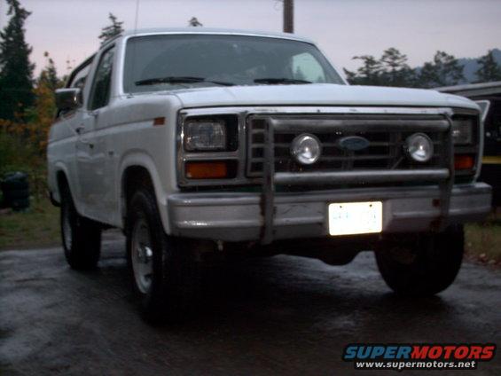 White 1986 Ford Bronco front view with brush guard and auxiliary lights