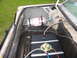 1985 Ford Crown Victoria LTD - The trunk of a car shows a nitrous oxide tank and a fuel cell, indicating performance modifications.