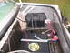 1985 Ford Crown Victoria LTD - The trunk of a car shows a custom fuel system and battery installation.