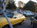 1978 Ford Mustang II - Yellow 1978 Ford Mustang II Mach 1 coupe with black stripe and side trim, parked in a lot with other vehicles.