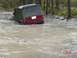 2005 Dodge 1500 - Jeep Wrangler submerged in muddy water, stuck off-road.