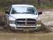 2005 Dodge 1500 - This Dodge Ram is navigating through a muddy off-road trail, kicking up a lot of water.