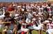 1996 Ford Mustang - A football team celebrates on the field in front of a large crowd in the stands.