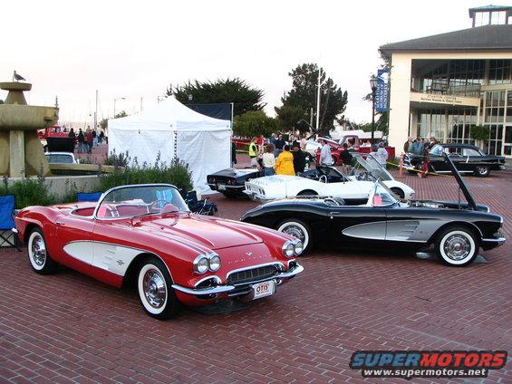 Red 1958 Chevrolet Corvette convertible parked on brick pavement