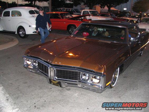 Brown 1969 Buick Riviera front 3/4 view with chrome grille and whitewall tires