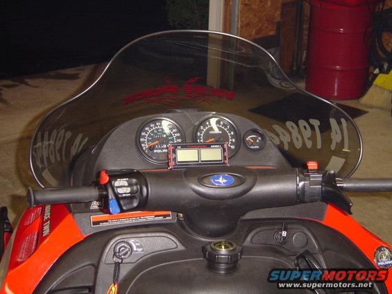Snowmobile dashboard with two main gauges, a smaller fuel gauge, and digital display