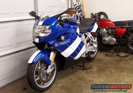 Blue and white BMW K1200S motorcycle parked next to a red motorcycle