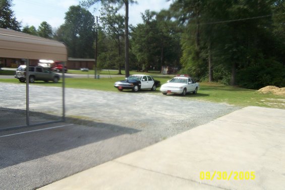 1998 Ford Crown Victoria police car, front 3/4 view, white and black