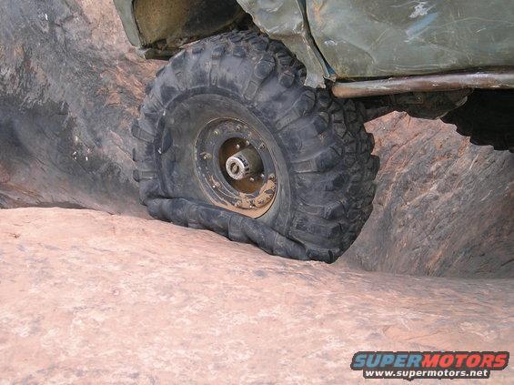 Off-road vehicle tire is flat on a rock surface