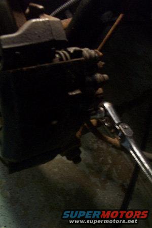 Disk brake caliper with a socket wrench