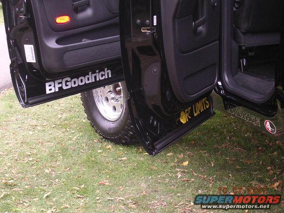 Black SUV doors open, showing BFGoodrich and OFF LIMITS decals on the rocker panels