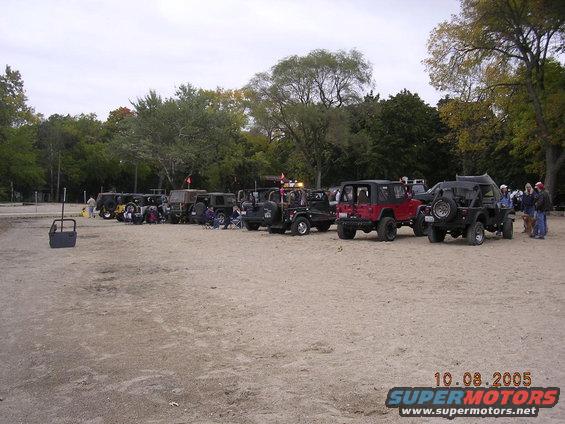 Several Jeeps parked on a sandy lot with trees in the background. A date stamp shows 10.08.2005