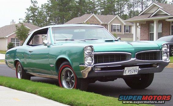 1967 Pontiac Lemans coupe, green, parked on street with redline tires