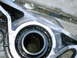 1990 Mitsubishi Eclipse - Close-up of a worn bearing within a metal component, showing signs of oil.