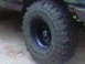1988 Ford Bronco - Off-road tire and wheel detail with Supermotors.net watermark.