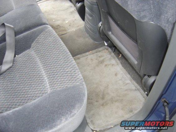 Interior rear seats and floor mats of a 1999 Ford Taurus