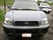 1999 Ford Taurus - Front view of a Hyundai Santa Fe, with a Ford Taurus visible in the background.