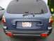 1999 Ford Taurus - Rear view of a blue Hyundai Santa Fe, a Massachusetts license plate.