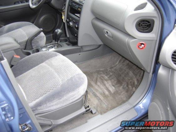 Interior view of a car showing the passenger seat, dashboard, and center console