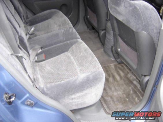 Back seat and floor of a car. Blue exterior visible on the left