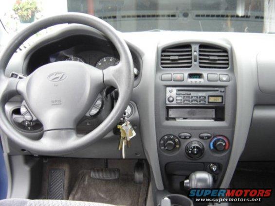 Interior view of a Hyundai Santa Fe showing the steering wheel, dashboard, and center console with radio