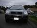 1999 Ford Taurus - A dark gray Hyundai Santa Fe is parked on an asphalt surface with a silver sedan in the background.