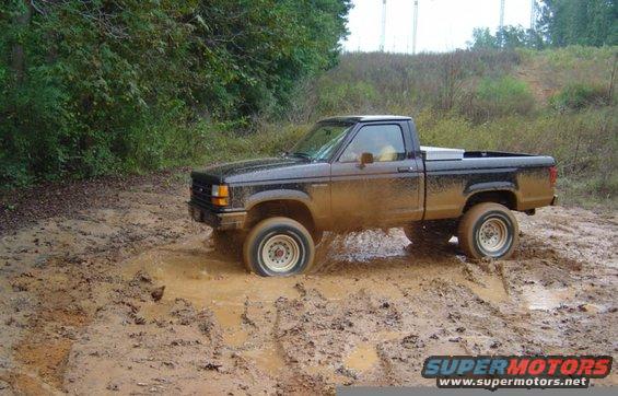 Black 1989 Ford Ranger stuck in mud, side view