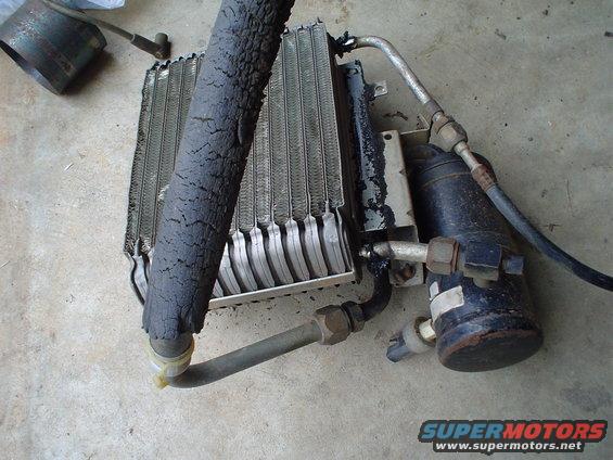 car AC condenser with a cracked hose and a receiver-drier unit