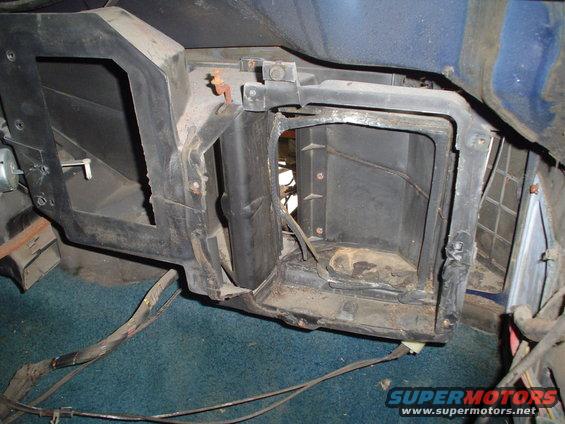 car's dashboard HVAC unit disassembled, showing ducting and wiring