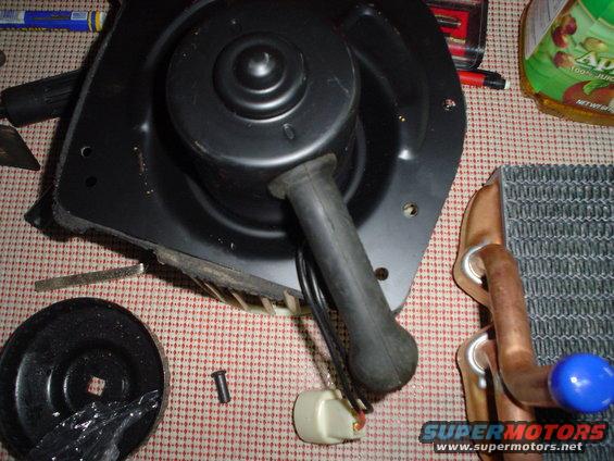 Blower motor and heater core parts on a checkered surface
