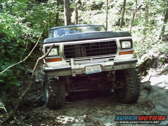 Ford Bronco on a muddy trail, front view. License plate reads 795 0105