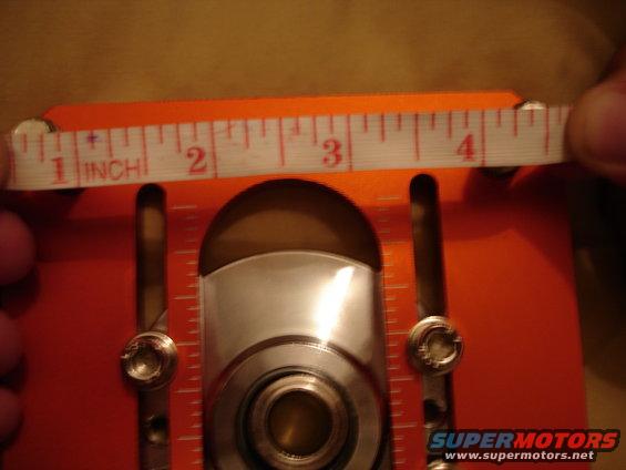 Orange measuring tool with ruler showing 1 to 4 inches