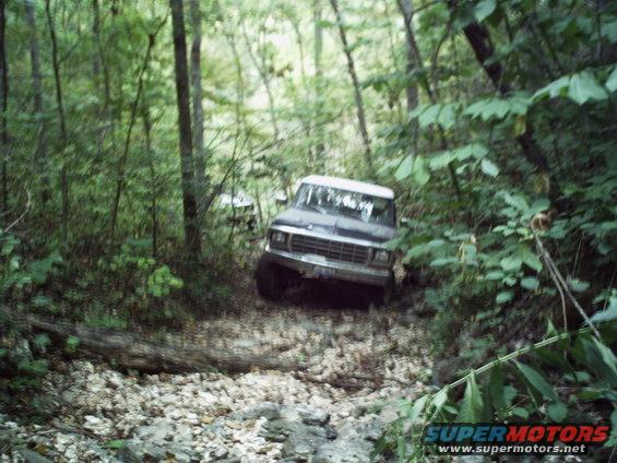 1980s Ford Bronco on wooded trail