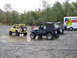 1990 Ford Bronco - Two Jeep Wranglers are parked in a muddy area, with a U-Haul truck visible behind them.