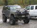 1990 Ford Bronco - This modified 1990 Ford Bronco features oversized tires and a unique hood adornment of trash bags filled with debris.