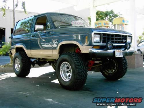 1986 Ford Bronco II with lifted suspension and large tires parked outside