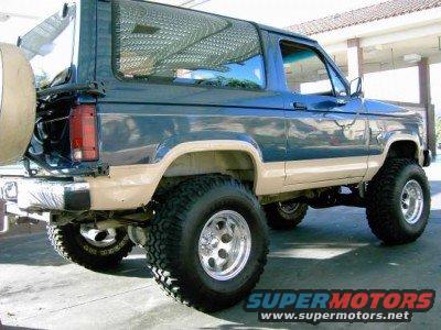 1986 Ford Bronco II, blue and tan, lifted with spare tire on rear