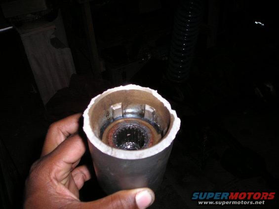Hand holding a metal tube showing a splined hub inside