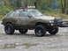 1990 Ford Bronco - This heavily modified Subaru hatchback is equipped for off-road adventures with its large tires and roof-mounted lights.