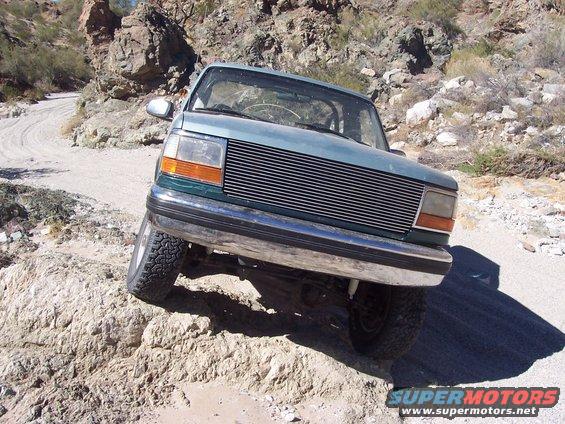 Teal Ford Explorer on a rocky trail
