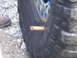 1990 Ford Bronco - A tire has a foreign object lodged in its tread, with a boot visible nearby.