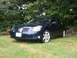 2005 Nissan Maxima - Front 3/4 view of a dark blue 2005 Nissan Maxima sedan.